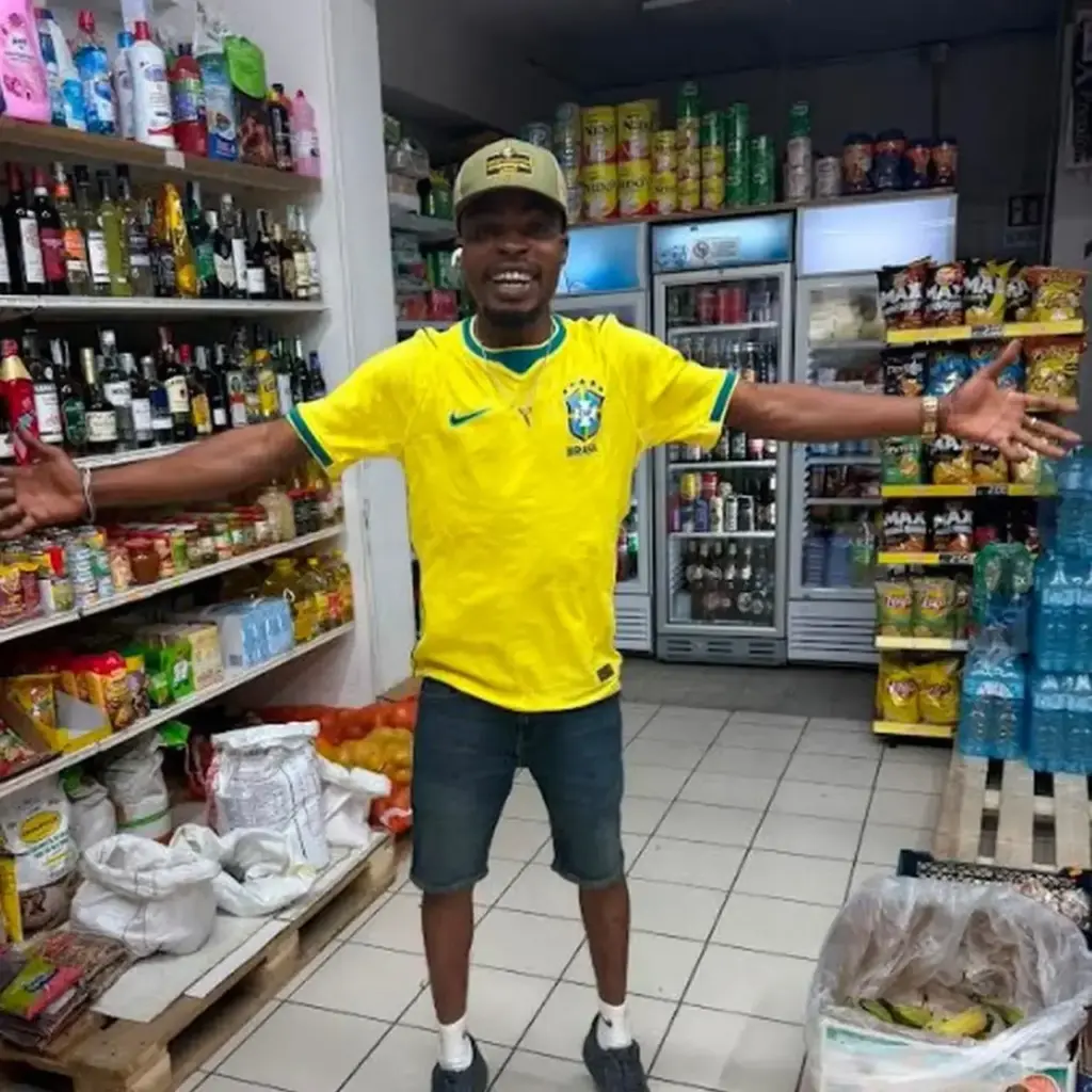 Imagbe Ehizomwengie, 36-year-old Nigerian celebrates in his cousin's shop