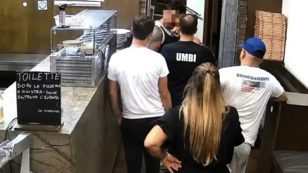 Umberto Carriera, from behind, confronted by the man who was filmed because of the trash left in front of his place